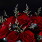 Bouquet of red roses with silver leaves against a dark background
