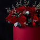 Red roses in a pink box with 'Flowrose' branding on a dark background